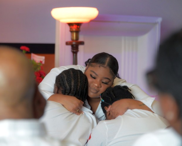 Relatives embrace during the funeral for Leslie Noble IV, the Franklin High School player who collapsed during a team practice. (Karl Merton Ferron/Staff)