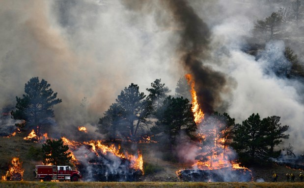 Firefighters battle the orange blaze of the Alexander Mountain fire west of Loveland on Tuesday, July 30, 2024. (Photo by Zachary Spindler-Krage/The Denver Post)