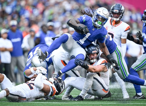 Brandon Jones (22) and Alex Singleton (49) of the Denver Broncos tackle Laviska Shenault Jr. (1) of the Seattle Seahawks during the fourth quarter of the Seahawks' 26-20 win at Lumen Field in Seattle, Washington on Sunday, Sept. 8, 2024. (Photo by AAron Ontiveroz/The Denver Post)