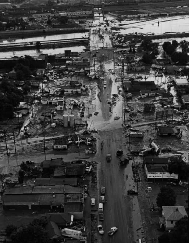 In this file photo from June 17, 1965, the view looking east down West Alameda Avenue shows debris piled up at the bridge across the South Platte River, the adjacent Valley Highway (now I-25) still under water and the devastation left along the street. On June 16, raging waters ripped through the metropolitan area, smashed bridges and virtually cut Denver in two. (Photo by Ed Maker/The Denver Post)