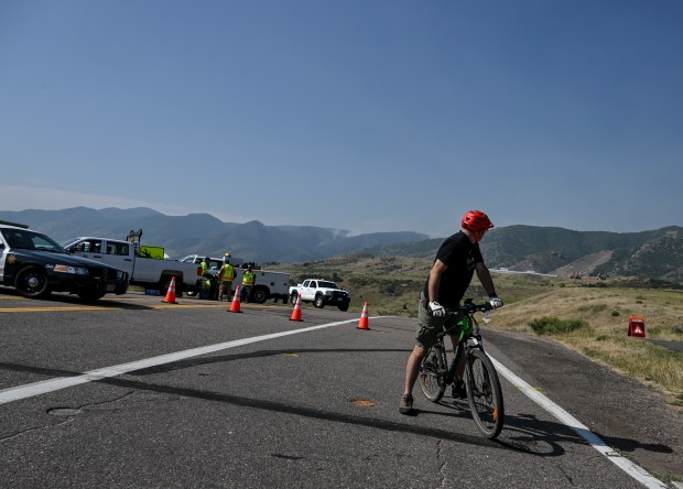 Jefferson County officials block a road in Ken Caryl as the Quarry fire burns near Littleton on Thursday, Aug. 1, 2024. (Photo by AAron Ontiveroz/The Denver Post)