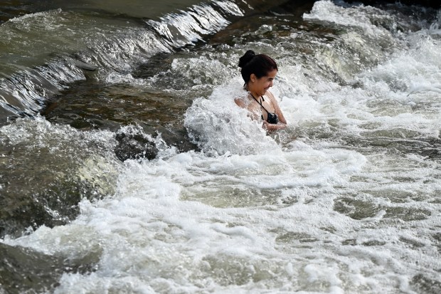 Victoria Britto tries to beat the heat by soaking in the cool waters of the South Platte River at Confluence Park as it runs through downtown in Denver on June 17, 2024. (Photo by Helen H. Richardson/The Denver Post)