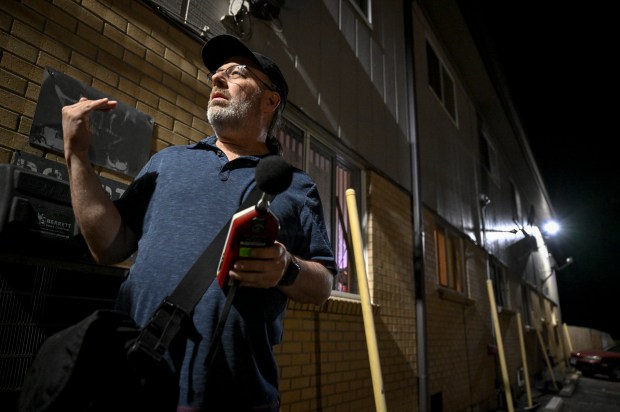 City noise investigator Justin Lamascus takes a reading during a routine noise investigation between Club Dubai and a residential multi-family unit at Mississippi and Federal in Denver on Tuesday, Aug. 13, 2014. (Photo by AAron Ontiveroz/The Denver Post)