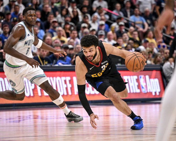 Jamal Murray (27) of the Denver Nuggets drives as Anthony Edwards (5) of the Minnesota Timberwolves hunts him from behind during the fourth quarter of the T-Wolves' 98-90 win at Ball Arena in Denver on Sunday, May 19, 2024. (Photo by AAron Ontiveroz/The Denver Post)