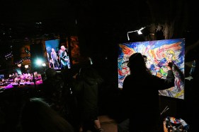 Live-music artist Keith “Scramble” Campbell paints a 3-by-4-foot abstract acrylic artwork of the bands performing at Red Rocks.