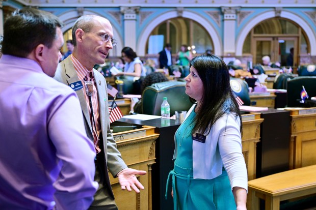 From left, Rep. Chad Clifford, Rep. Mike Weissman, and House Minority Leader Rose Pugliese discuss property tax legislation during the special session in the House Chamber at the Colorado State Capitol in Denver on Tuesday, Aug. 27, 2024. (Photo by Hyoung Chang/The Denver Post)