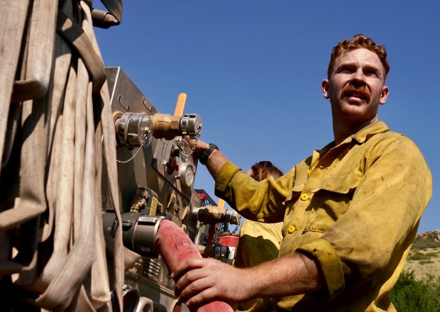 Firefighter Jack Pemberton refills a firetruck before returning back up Stone Canyon Road to continue fighting the Stone Canyon fire near Lyons on Thursday, Aug. 1, 2024. (Photo by Zachary Spindler-Krage/The Denver Post)