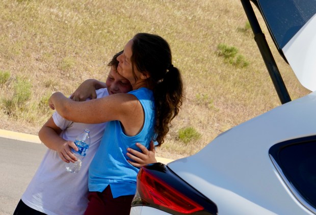 Kate Newell embraces her son Adam after an evacuation order was lifted for their home in Lyons on Thursday, Aug. 1, 2024. Their home was a quarter mile away from where the fire was suppressed off of Stone Canyon Road. (Photo by Zachary Spindler-Krage/The Denver Post)