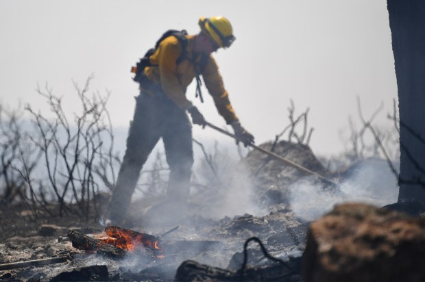 Firefighters try to quell flames near a home being threatened by the Stone Canyon fire near Lyons on Wednesday, July 31, 2024. (Photo by Zachary Spindler-Krage/The Denver Post)