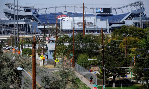 Invesco Field towers over the Sun Valley neighborhood in Denver in a file photo. Secluded and isolated, Sun Valley long has been the poorest neighborhood in the city. Of the 1200 residents, over 900 live in the projects. (Photo by Craig F. Walker/The Denver Post)