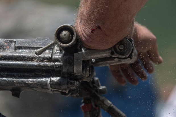 Bleeding from a fresh wound, Gilbert Meador works a jackleg drill in the single man drilling competition at the 50th Hardrockers' Holidays in Silverton on Saturday, Aug. 10, 2024. (Photo by William Woody/Special to The Denver Post)