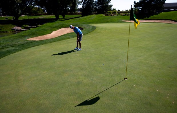 Austin Barry, a golfer for Fossil Ridge High School, practices his putting on the green of hole 18 for a photo at Ptarmigan Country Club in Fort Collins, Colorado, on Saturday, Sept. 7, 2024. Barry, a senior at Fossil Ridge, shot a 59 in a league tournament recently. (Photo by Alex McIntyre/Special to The Denver Post)