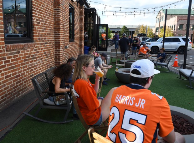 Fans and visitors gather outside at Raices Brewing Company, near Empower Field at Mile High, before a Broncos game on August 27, 2022, in Denver. (Photo By Kathryn Scott/Special to The Denver Post)